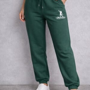 GREEN SWEATPANTS WITH A WHITE LOGO ON THE LEFT SIDE